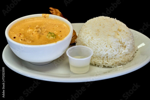 Obraz Side view of Thai traditional spicy Red curry with chicken and streamed rice