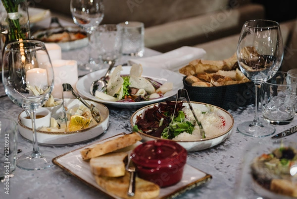 Fototapeta Food and drink on the dining table. Plate and glass. Wedding set up, dinner table reception in a restaurant. Serving, setting table in the hall. Birthday, baptism, event.