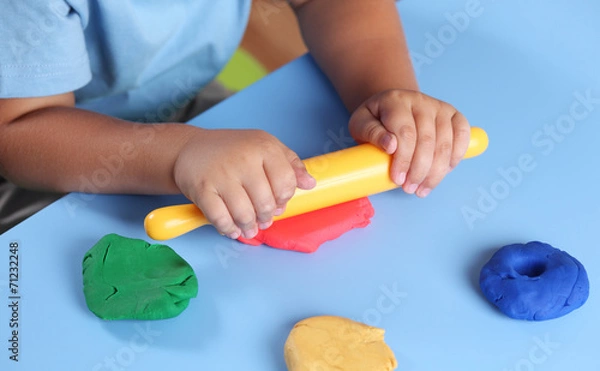 Fototapeta Child playing with modeling clay