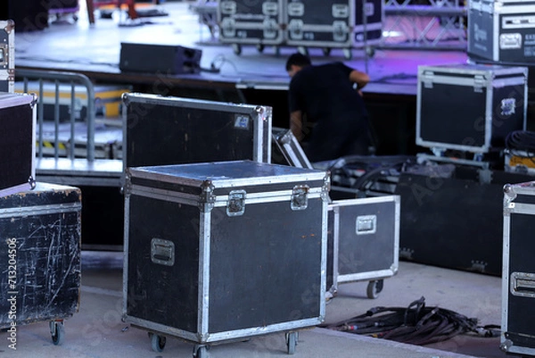 Fototapeta Technician working. Drawers for carrying equipment for shows and setting up stages. Trunks for technical equipment for events. Technical setup of stage for show with lights and sounds. 