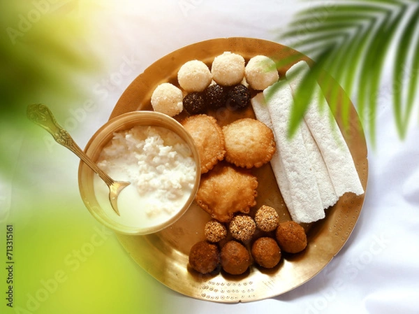 Obraz Assamese traditional food items like pitha, laddu, doi sira with assamese gamosa background with japi motifs