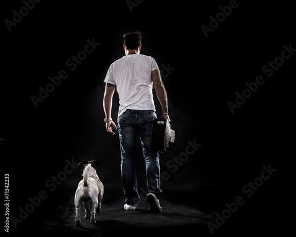 Fototapeta Boy Walking away , see from behind , with dog and guitar