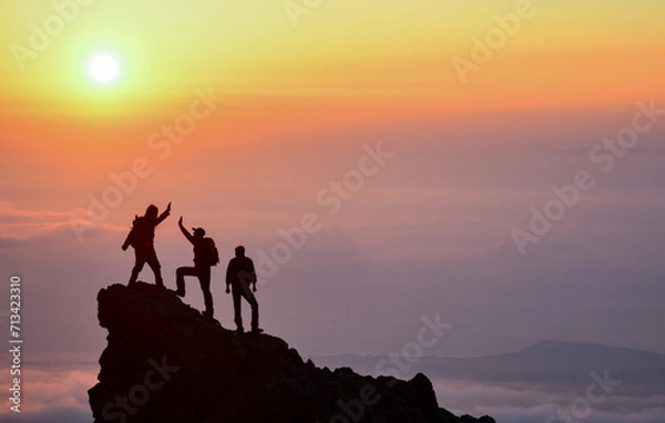 Obraz Young climbers congratulate each other at the summit