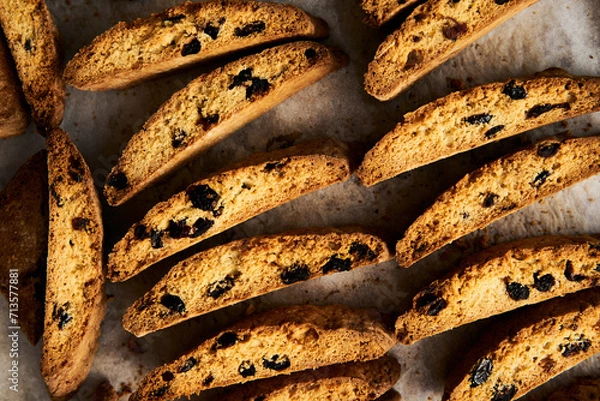 Obraz Golden Biscotti or Cantuccini on the baking pan. Traditional Sweet Italian cookies that are making with two times baking, with nuts and dried cranberries. Extra crunchy and dry. Top view
