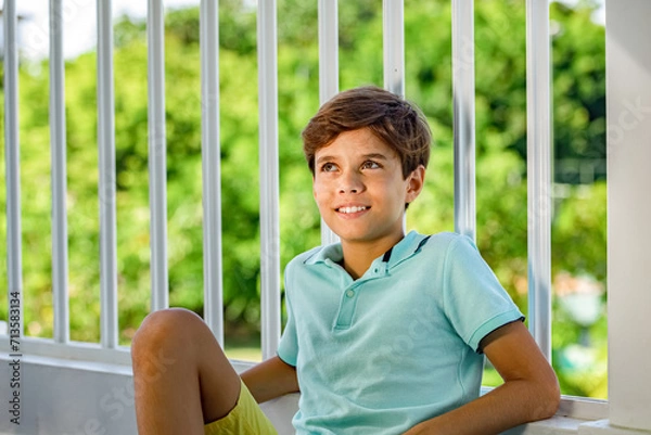 Obraz Handsome smiling teenager's portrait on green garden background