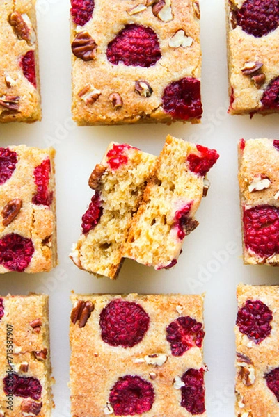 Obraz Blondies with raspberries and pecan nuts. White background. Top view