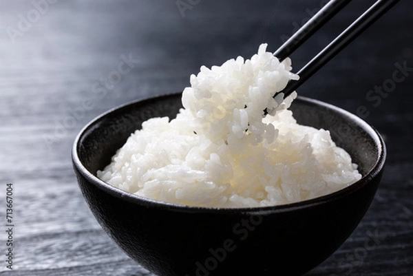 Obraz ご飯を箸で食べる