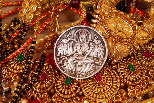 Fototapeta gold jewelery IN wooden Durga, Saraswati or laxmi silver coin isolated on white background . indiaan god.