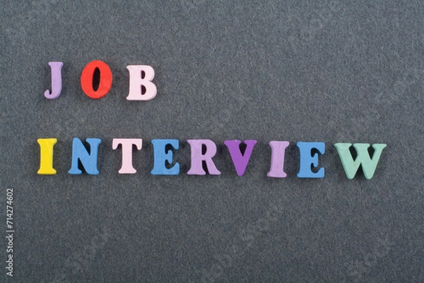 Fototapeta JOP INTERVIEW word on black board background composed from colorful abc alphabet block wooden letters, copy space for ad text. Learning english concept.