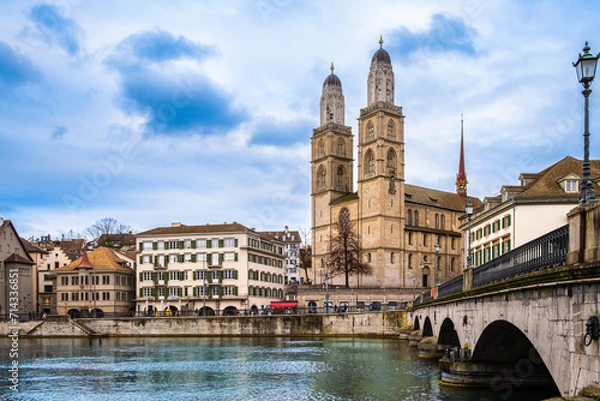 Fototapeta Panoramic view of Zurich city center, Switzerland. Zuerich old town with famous Fraumunster and Munsterbrucke bridge on bank of river Limmat in winter