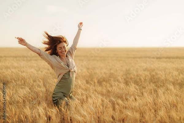 Obraz Caught in a burst of joy, a woman dances freely in the wheat field, her figure silhouetted against the soft glow of the setting sun