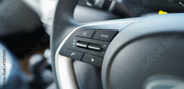 Fototapeta Hand operating switch on the car, car interior button, Interior of the car with cruise control buttons, Hyundai i20: 5 Features stock images