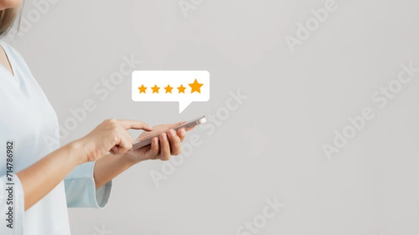 Fototapeta customer satisfaction survey concept businesswoman use smartphone Touch the happy smiley icon. Satisfied. 5 stars. Service experience rating. online application Satisfaction Review best quality.