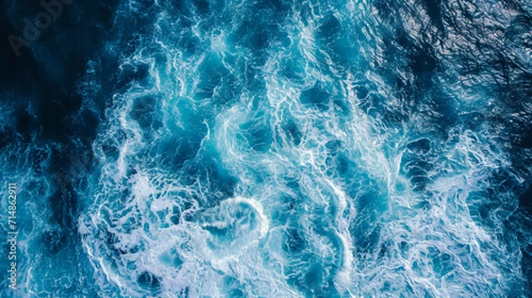 Fototapeta waves in the open ocean, capturing the vast energy spread across the water, varying sizes of waves, realistic blue hues of the sea, under clear skies