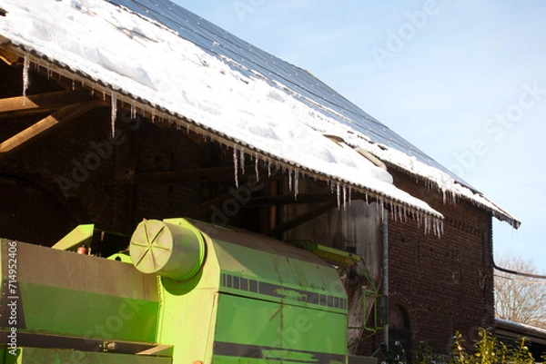 Fototapeta agricultural machine in front of barn