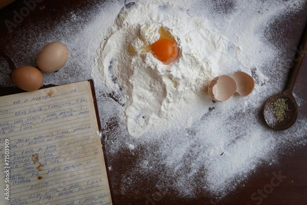 Fototapeta Dough ingredient on the table with old cook book