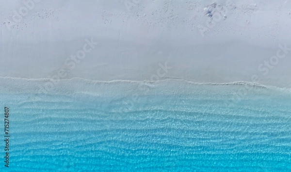 Fototapeta The soft wave water of the sea on the sandy beach background