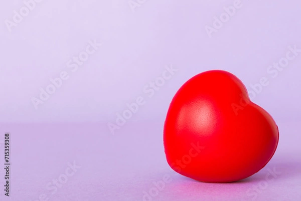 Fototapeta gift box with red bow and red heart on colored background. Perspective view. Flat lay