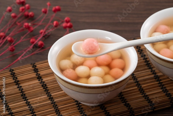 Fototapeta Red and white tangyuan with syrup soup.