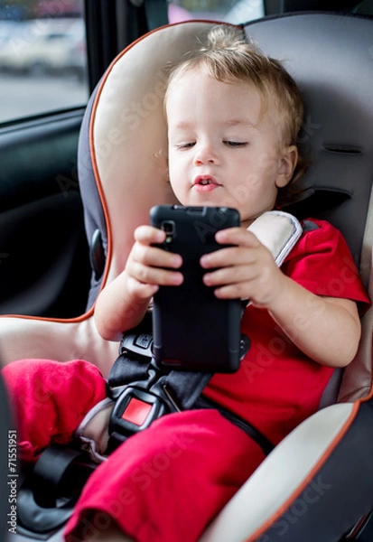 Fototapeta toddler boy playing smartphone