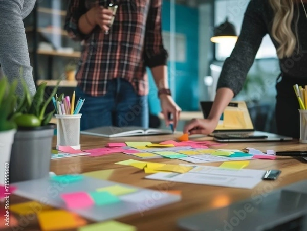 Fototapeta Professionals Brainstorm Ideas Together, Employing Schedules, Sticky Notes, And Innovation