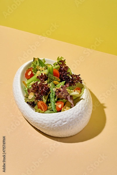 Fototapeta Salad with asparagus on a bright background.