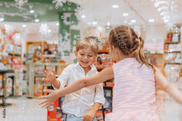 Obraz Happy Siblings Playing with Soap Bubbles
