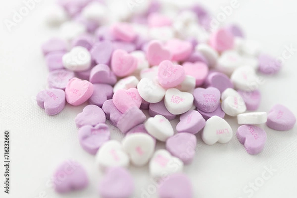 Fototapeta Background for Valentine's Day. Assorted pink, purple, white heart shaped candies with printed messages of love. Messages about kisses. Gift for Women's Day, March 8