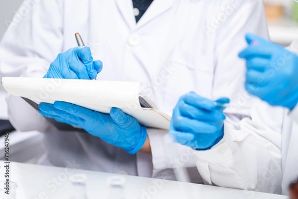 Fototapeta A Scientists or nutritionists are working on a sample of milk in biotechnology laboratory, genetic and bacteria research, dairy product quality control, protein, glucose and lactose percentage test.
