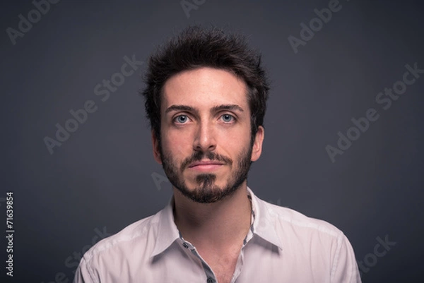 Obraz Man close up portrait against dark background.