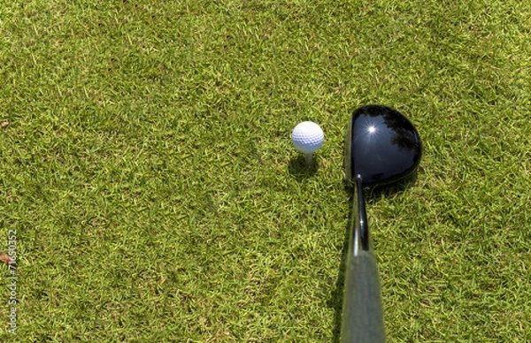 Fototapeta Top view of golf driver and ball on tee
