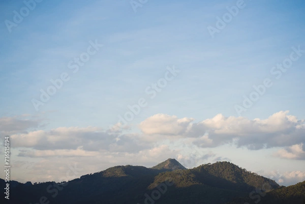 Fototapeta travel in nature concept with tropical forest on mountain and clear sky in springtime season