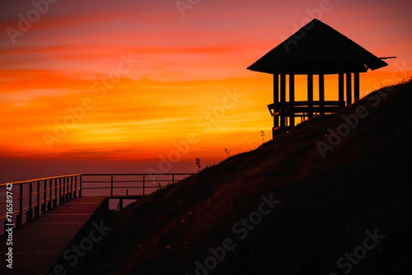 Fototapeta Silhouette pavilion by the hill during the dusk sky with the moon and tourists camping on the Doi Pui Co mountain in Thailand. Scenic landscape, Hiking trails, and camping in Northern Thailand