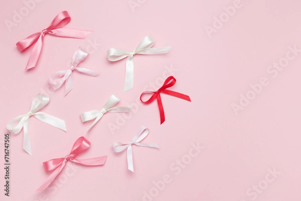 Fototapeta Multicolored bows on pink background. Top view, copy space