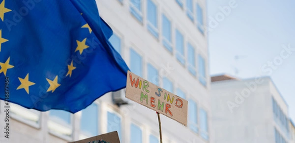 Fototapeta Flag of European Union and protest sign at demonstration against far-right political party AfD, hate and racicsm, anti-fascist demonstration in Nürnberg, Bayern, Germany