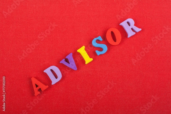 Fototapeta ADVISOR word on red background composed from colorful abc alphabet block wooden letters, copy space for ad text. Learning english concept.