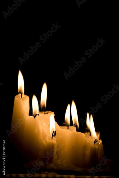 Obraz Group of white candles burning in the dark