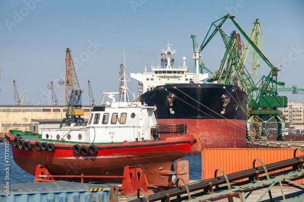 Fototapeta Red pilot boat stands on pier in Varna port, Bulgaria