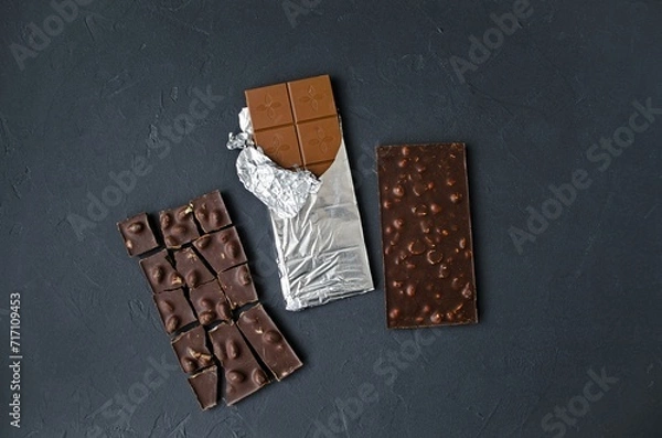 Obraz Sweet temptation: two chocolate bars on a dark background. Flat lay, top view. A combination of milk and dark chocolate.