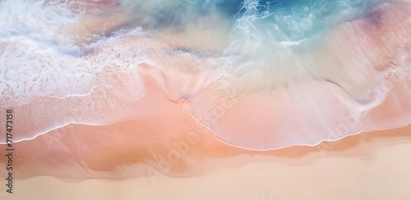 Fototapeta Splashing waves rolling on a beautiful beach with light brown water