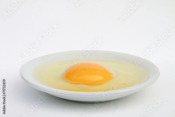 Fototapeta raw egg in the plate