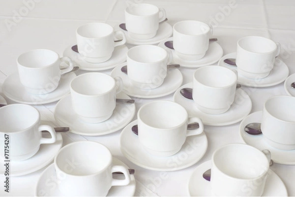 Fototapeta Group of white coffee cups in cafe bar