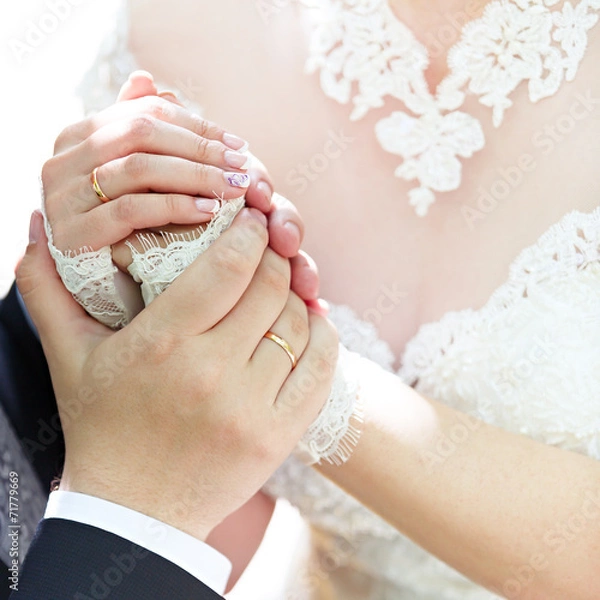 Obraz Hands of the groom and the bride with wedding rings