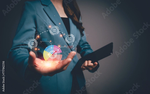 Fototapeta Businesswoman analyzing business enterprise data management metrics and KPIs to performance organization. analyst with business charts, Corporate strategy for finance, sales, marketing, operations.