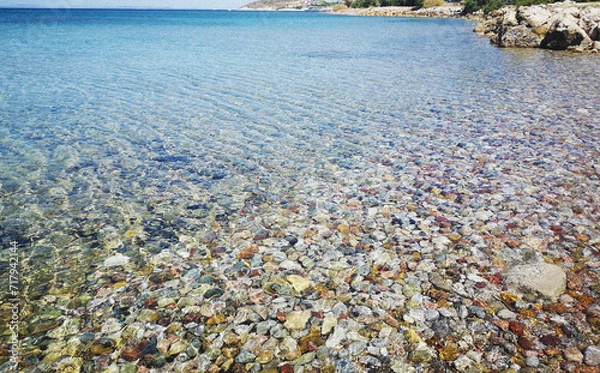 Fototapeta Waves on the beach. Ripples in water, view from above with sunlight. Natural Flow of Water. Minimal Background. Health, travel, holiday concept banner with empty copy space 