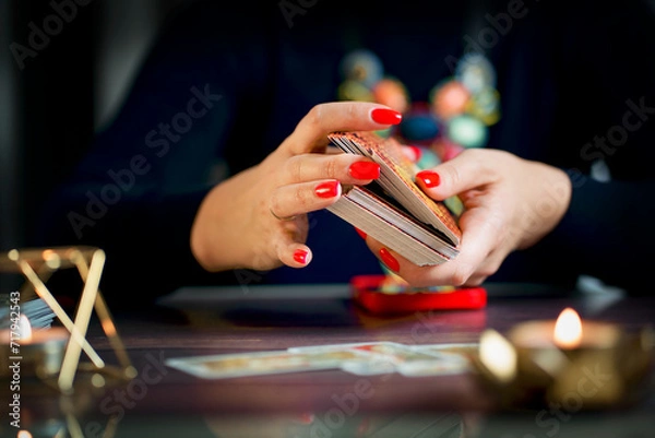 Fototapeta Selective Focus of two hands shuffling and adjusting tarot cards
