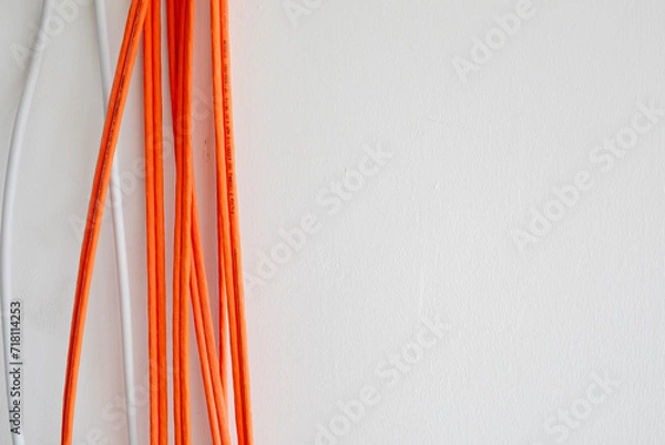 Fototapeta Orange cables in a rack ready for wiring..