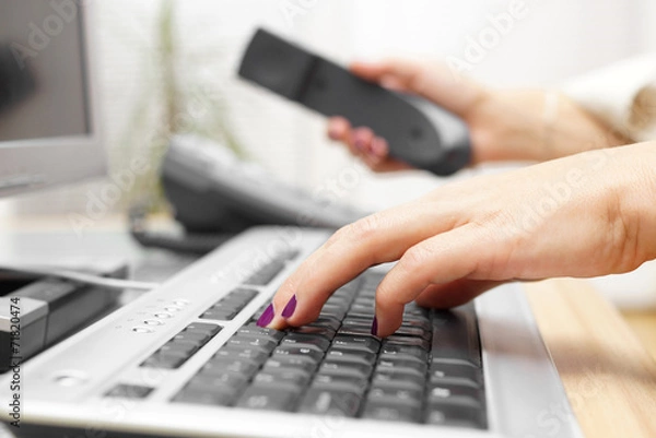 Fototapeta Businesswoman is typing on keyboard and answer the call. custome