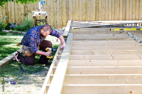 Obraz Carpenter drilling on deck