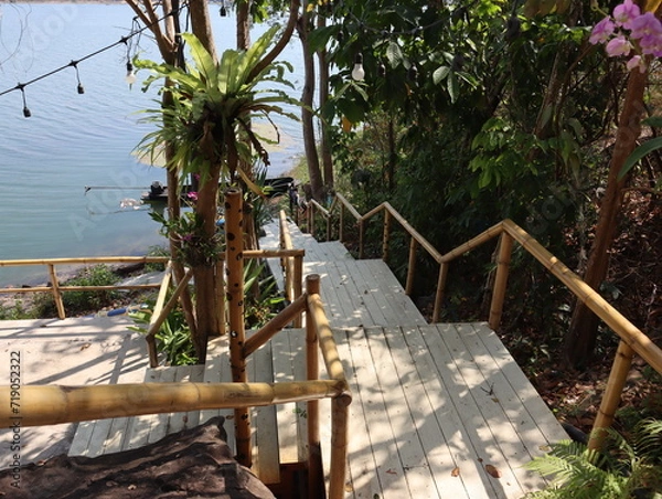 Obraz Wooden steps up the shelter surrounded by green nature.